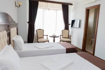 Фото номера Стандартный двухместный номер с 2 отдельными кроватями Отель Hotel Giuliano г. Бухарест 5